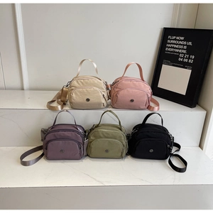 Multiple colors of nylon crossbody bags shown in beige, pink, purple, green, and black