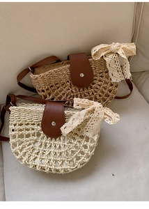 Close-up of hollow woven straw bags with leather flap and delicate lace bow detail