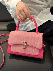 Pink vegetable tanned leather crossbody bag with woven texture and gold clasp lock