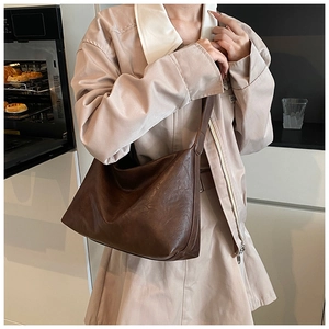 Close-up of vintage brown oversized tote bag with premium faux leather texture detail