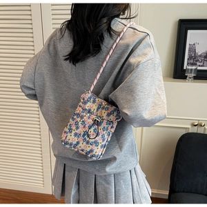 Detailed back view of a floral canvas crossbody phone bag with drawstring closure