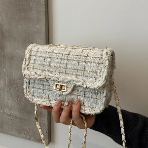 Elegant tweed crossbody bag with gold chain strap and metallic rectangular lock closure