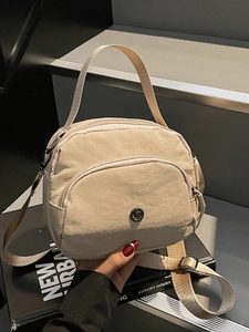 Multi-compartment beige nylon handbag with adjustable shoulder strap and metal logo