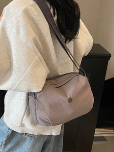 Minimalist purple nylon crossbody bag with wide strap for casual daily use and street style