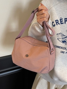 Minimalist dusty pink nylon crossbody bag with adjustable strap for daily casual outings