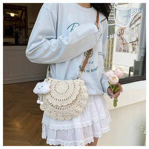 Detail of crochet saddle bag with lace hollow design and white cloud charm accessory