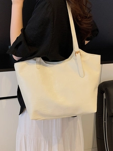 Large cream faux leather tote bag with adjustable strap for commuting and daily use