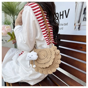 Detail of hand-woven crochet saddle bag with scallop edges and cloud charm