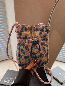 Floral woven crossbody bag with pink drawstring shoulder strap and vintage floral patterns