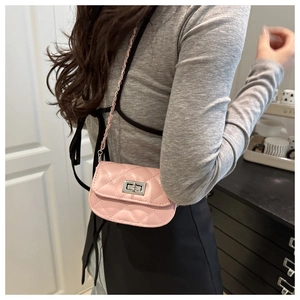 Detailed view of pink quilted PU leather mini chain bag with silver twist lock and strap