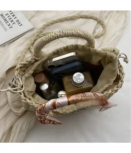 Detailed interior of woven bucket bag showing capacity for phone and perfume