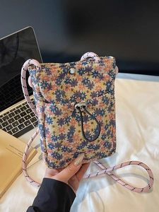 Floral woven crossbody phone bag with pink braided rope strap and magnetic closure