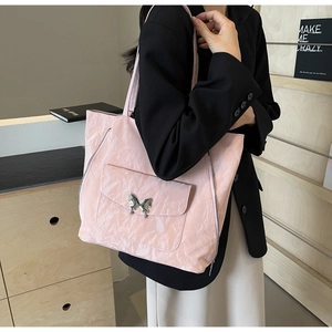 Detail of pink tote bag showing unique crinkled texture and silver butterfly buckle