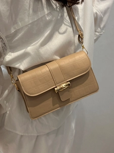 Chic beige crocodile pattern leather crossbody bag with iconic golden bamboo lock detail