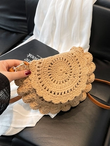 Handheld khaki crochet saddle bag with wavy edge and brown leather strap for summer beach