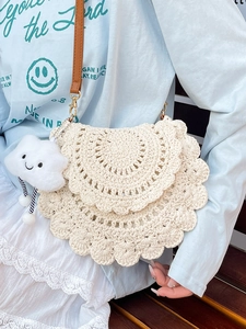 Cream crochet saddle bag with brown leather strap and smiling cloud charm for summer beach