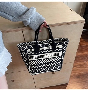 Macro detail of high-quality woven canvas fabric with ethnic geometric patterns on tote