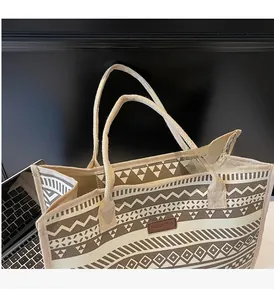 Detail of retro geometric canvas tote bag with braided handles and fashion leather patch
