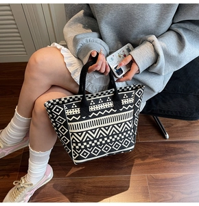 Close-up of geometric pattern on durable canvas tote bag with woven handles
