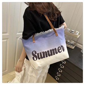 Detailed shot of large canvas tote bag with purple gradient, fringe edge, and Summer text