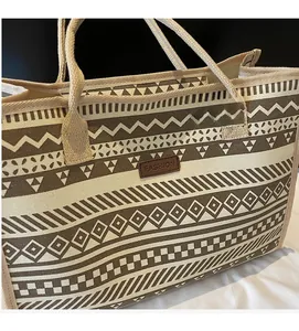 Detail view of ethnic geometric canvas tote bag with fashion leather patch and woven handles