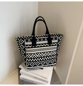 Detail of large canvas tote bag with black and white geometric patterns on books