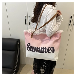 Detail of pink gradient canvas tote bag featuring Summer lettering and fringe edges