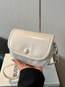 Chic cream white glossy flap shoulder bag with textured finish and silver hardware
