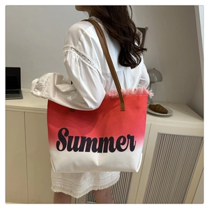 Detail of pink gradient canvas tote bag featuring Summer embroidery and fringe edges