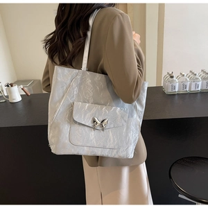 Silver metallic tote bag with wrinkled marble texture and a silver butterfly buckle detail
