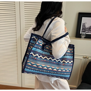 Close-up of large canvas tote with ethnic geometric patterns worn on the shoulder