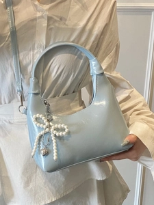 Light blue glossy patent leather hobo bag with pearl bow charm and silver heart pendant