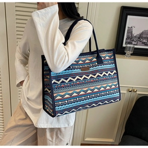 Detailed close-up of a large bohemian canvas tote bag featuring geometric ethnic patterns