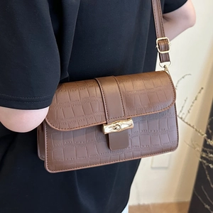 Brown crocodile embossed shoulder bag with gold bamboo twist lock on flap cover