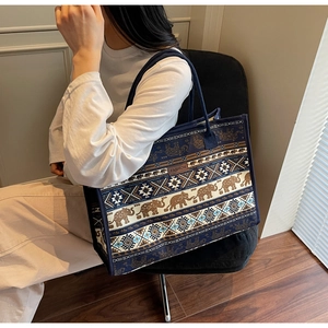 Detailed macro view of the ethnic elephant pattern on the large canvas tote bag