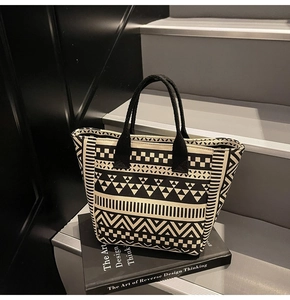 Close-up of geometric pattern canvas tote bag with striped and checkered details