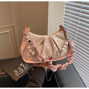 Detail of pink jacquard satin cloud bag with pearl and silver floral chain decoration