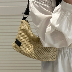 Beige woven shoulder bag with black leather straps and silver rings for summer wear