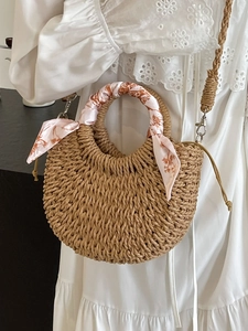 Handwoven straw crescent handbag with floral silk scarf handle and adjustable strap