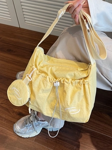 Casual yellow nylon tote bag with drawstring pocket and matching round coin pouch