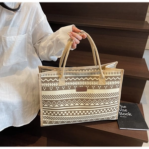 Detail of retro geometric canvas tote bag showing braided rope handle and fashion patch