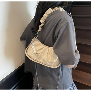 Detail of ruched cream cloud bag with pearl floral chain and ruffled shoulder strap