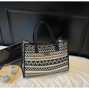 Ethnic geometric canvas tote bag showing spacious interior with laptop and headphones