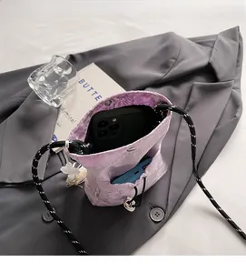Detailed interior view of a purple embroidered bucket bag holding a smartphone and power bank