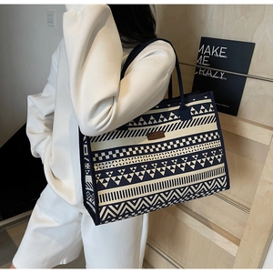 Detail of vintage geometric canvas tote bag showing textured fabric and fashion leather patch