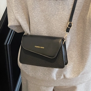 Classic black crossbody bag for women with gold lettering and adjustable shoulder strap