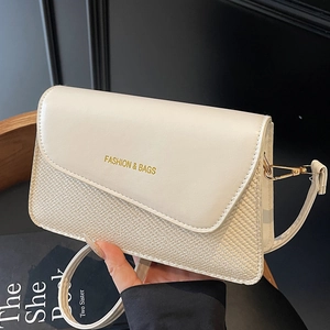 Chic beige crossbody bag with woven texture, wide strap, and gold fashion hardware