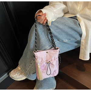Close-up of butterfly embroidery and tassel on pink Chinese style drawstring bucket bag