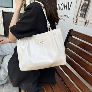 Minimalist cream white tote bag with silver bow charm and subtle side pleats