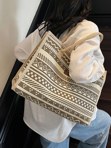 Vintage bohemian canvas tote bag with brown geometric patterns and woven rope straps